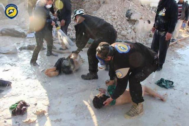 Photo of Syrian 'White Helmets' allegedly checking Sarin victims from the Idlib bombing. Not the striking lack of any protective equipment